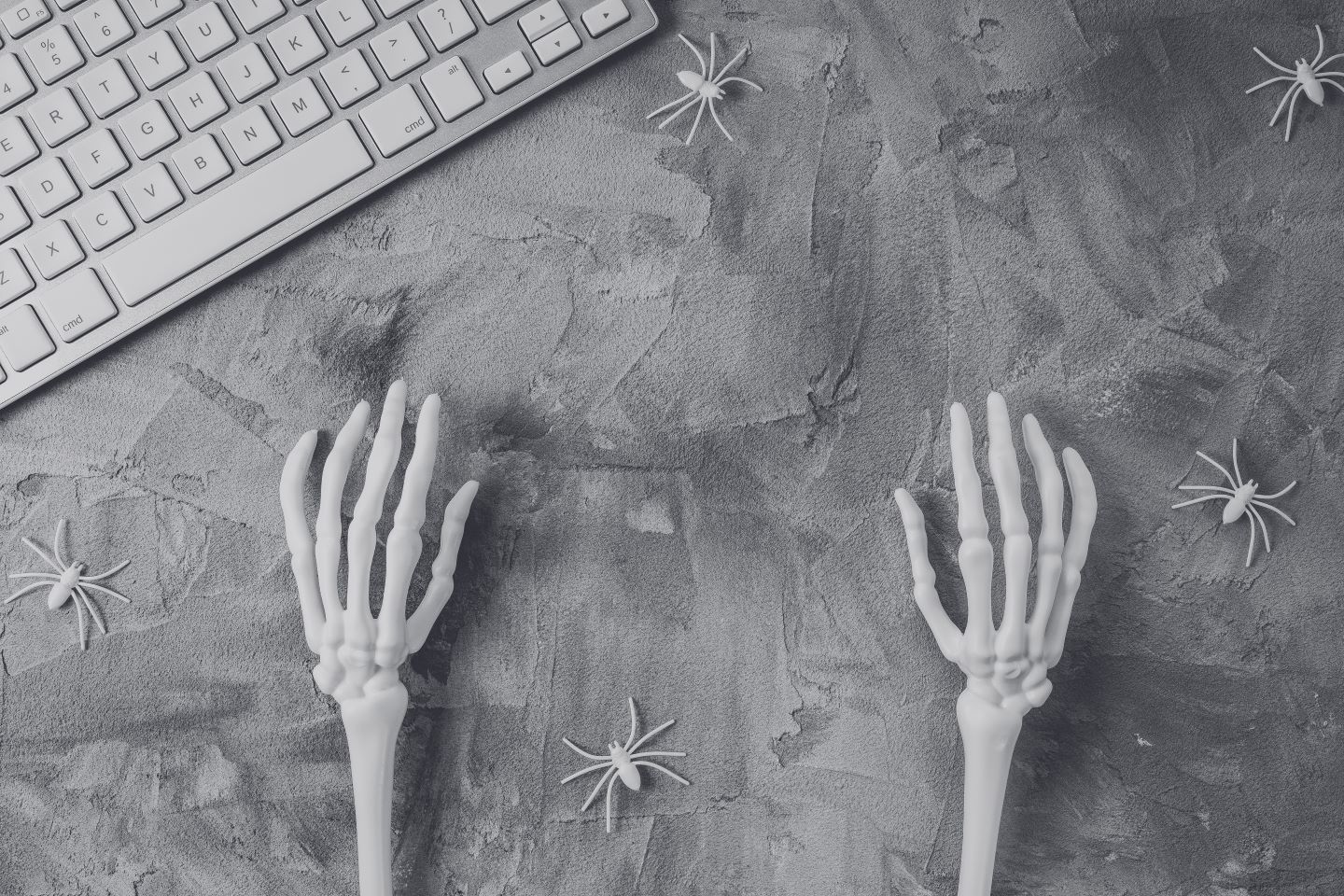 Skeleton hands at a computer keyboard