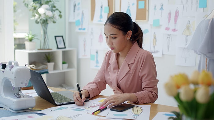 Female remote worker, dressed in business suit, working from home.